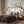 Neutral landscape wall art above a bed with brown and grey bedding