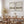 Beige watercolor landscape prints with birds in black frames above a wooden dining table
