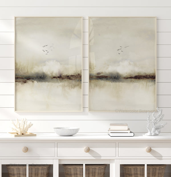 Set of 2 beige landscape prints with birds above a white sideboard with coral decor