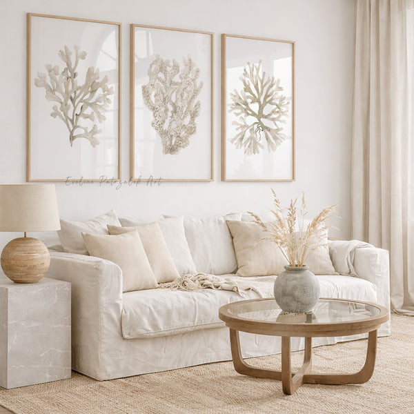 Living room with a white sofa, wooden coffee table, and framed coral art on the wall.