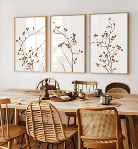 A framed watercolor painting showcases the intricate details of rose hips, painted in rich burnt sienna tones viewed from numerous angles. 