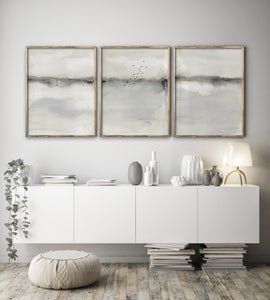 An abstract landscape scene in muted shades of gray and white is seen from multiple angles.