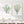 Sage green coral and sea fan watercolor prints on a white shiplap wall above a console