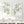 Sage green leaf wall art set of 2, watercolor branch prints above a white sideboard