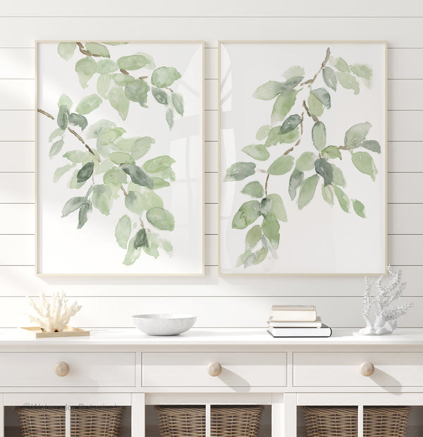 Sage green leaf wall art set of 2, watercolor branch prints above a white sideboard