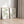 Two watercolor leaf prints in oak frames leaning on a light wood floor