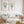 Sage green sea fan wall art set of 2 in a bright living room with a white sofa and rattan chair
