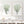 Sage green sea fan prints on a white shiplap wall above a white console with baskets