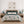 Four neutral sea life prints above a bed with teal floral bedding