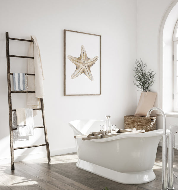 Single sand beige starfish print in a white bathroom with a freestanding tub