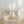 set of 2 prints standing on the floora nd leaning against white panelled wall in wooden frames showing 2 hummingbirds facing each other