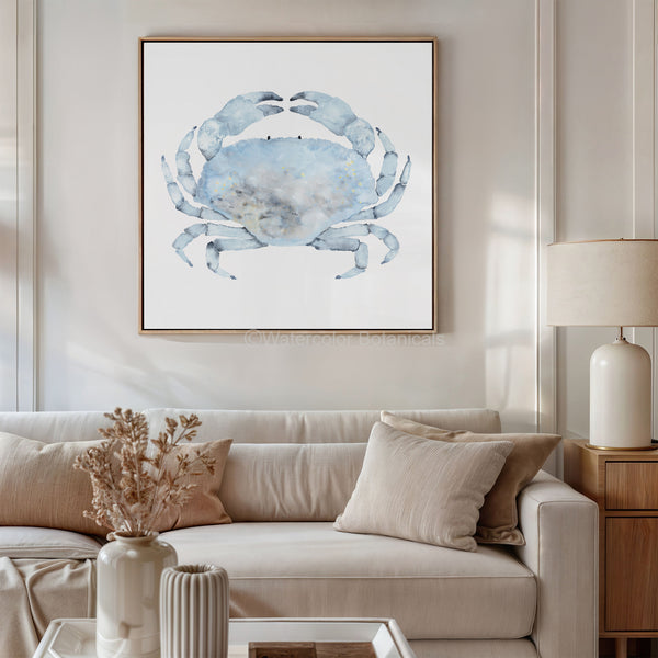 Living room with a beige sofa, decorative pillows, and a framed blue crab painting on the wall.