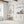 Single vintage wildflower print in a white kitchen with open shelves