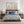 Pair of vintage wildflower prints above a bed with blue paisley bedding