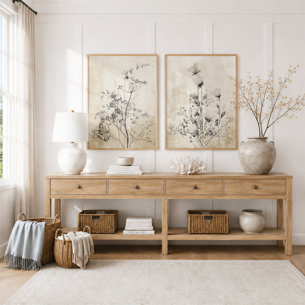 Farmhouse wall art with black wildflowers above an oak console table with baskets