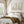 Vintage wildflower prints above a wooden bed under exposed ceiling beams