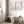 Two wildflower prints above a rustic wooden bench in a bright hallway