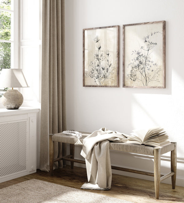 Two wildflower prints above a rustic wooden bench in a bright hallway