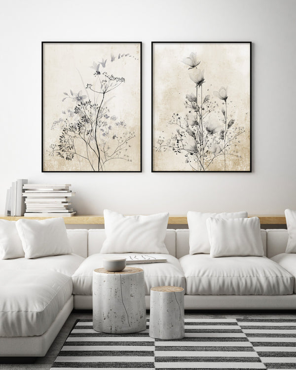 Black framed wildflower prints above a white sectional sofa