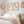 A pair of framed watercolor paintings depicting elegant great blue herons in soft neutral tones against a vintage-inspired background. The paintings are displayed on a white wall above a bed in a bedroom with a serene and calming atmosphere.