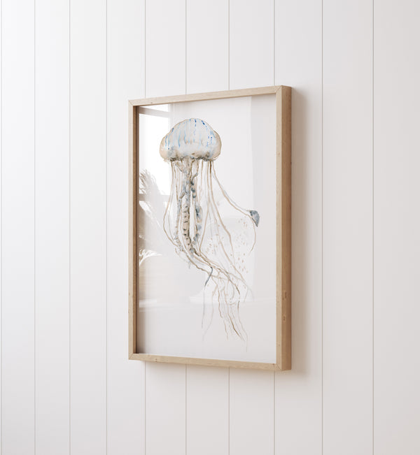 Close-up of the jellyfish print in a light oak frame on a white panelled wall