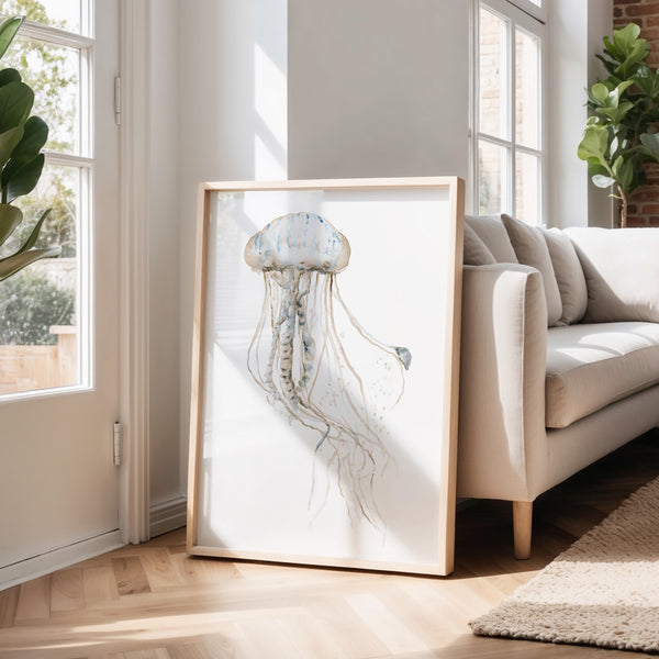 Large jellyfish print leaning against a wall next to a linen sofa in a sunny living room