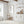 Jellyfish print in a gold frame in a white kitchen with open shelves
