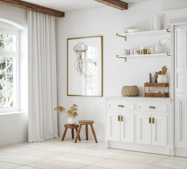 Jellyfish print in a gold frame in a white kitchen with open shelves