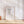 Large jellyfish print leaning against a white panelled wall on a herringbone floor