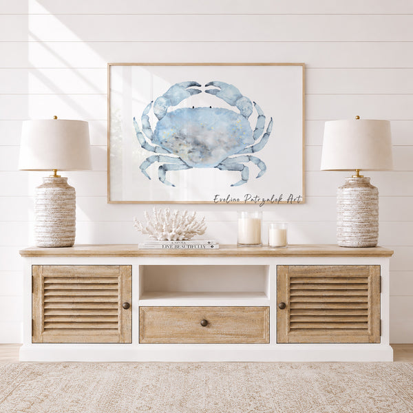 Nautical-themed room with a wooden console table, framed crab art, and decorative items.