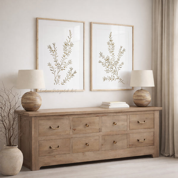 Wooden dresser with two lamps and neutral  botanical watercolor wall art showung minimalist olive branches in a room setting. 