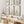 A gallery wall of six botanical illustrations showcasing various wildflowers in black ink on a vintage-inspired tan background. The artwork is displayed in a serene living room setting with a natural wood bench and neutral decor.
