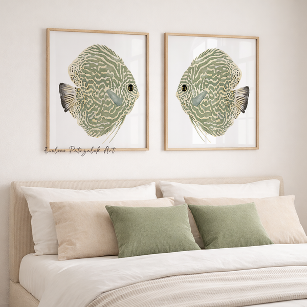Two framed prints of green fish on a wall above a bed with decorative pillows.