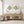 Living room with wooden console table, decorative items, and framed artwork showing discus fish in sage green.