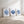 Three framed prints of blue coral and shell designs on a white wall.