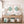 Nautical-themed room with  framed teal fish artwork, wooden console table, and decorative items - all decorated in coastal farmhouse style.