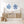 Nautical-themed room with wooden sideboard, blue coral art, and woven baskets.
