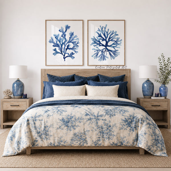 Bedroom with dark blue floral bedding, blue lamps, and navy blue minimalist wall art showing set of 2 blue corals painted against white background and in wooden frames